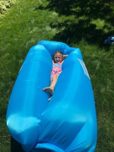 Young girl in a blue air couch