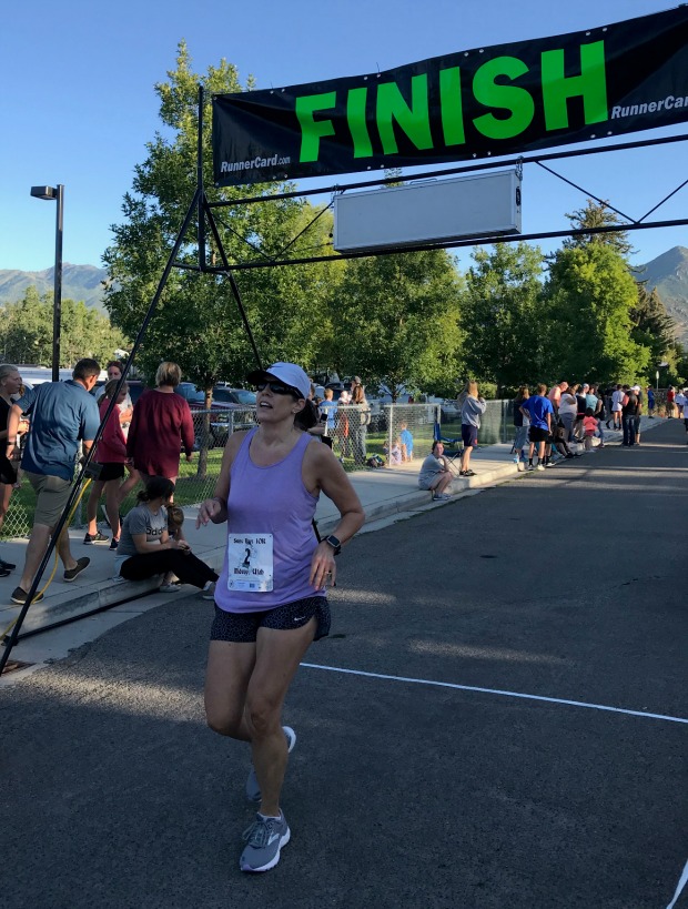 Female runner crossing the finish line.