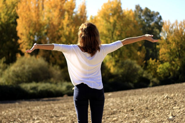 Woman with arms spread.