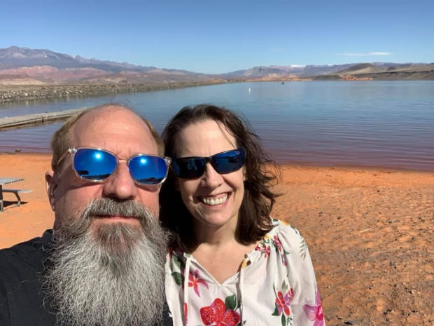 Couple in front of a reservoir.