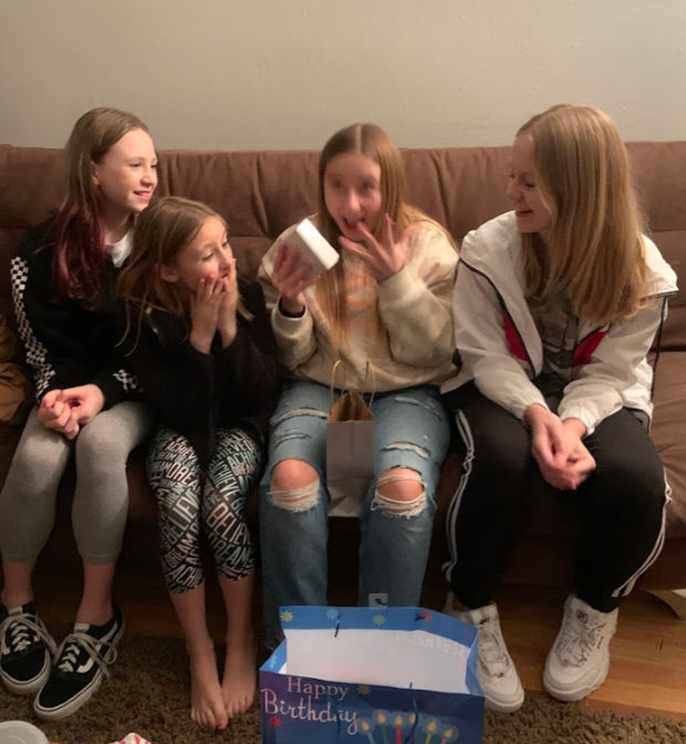 Four teenage girls at a birthday party.