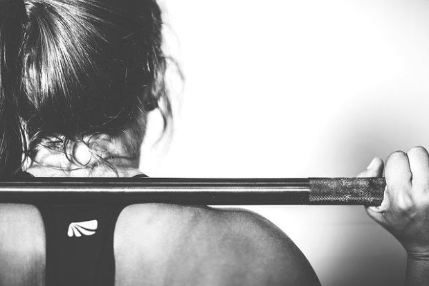 Strong woman with weights.