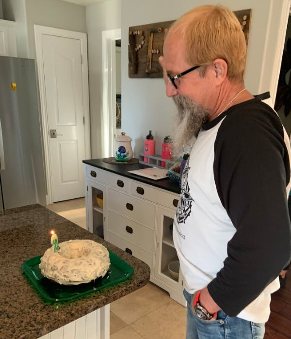 Man blowing out birthday candle.