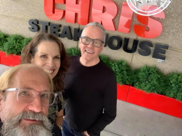 Three friends in front of Ruth's Chris Steakhouse.