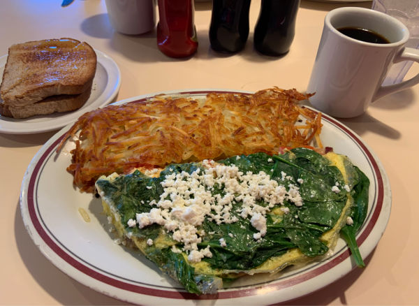 Spinach omelet with hash browns, toast, and coffee.
