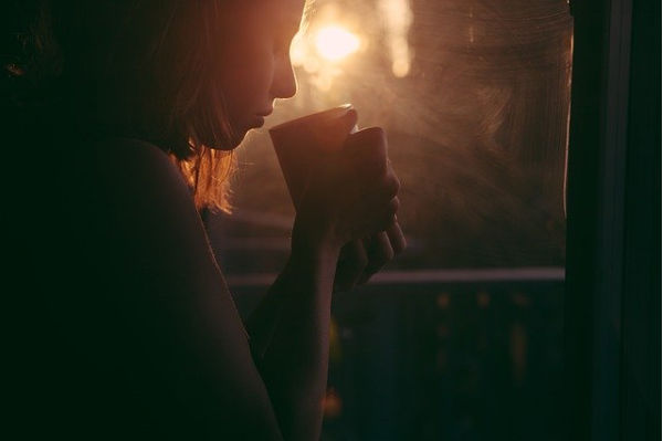 Woman smelling coffee.