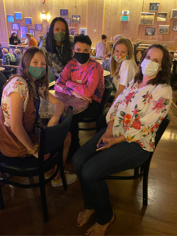 Family wearing masks in the theater.