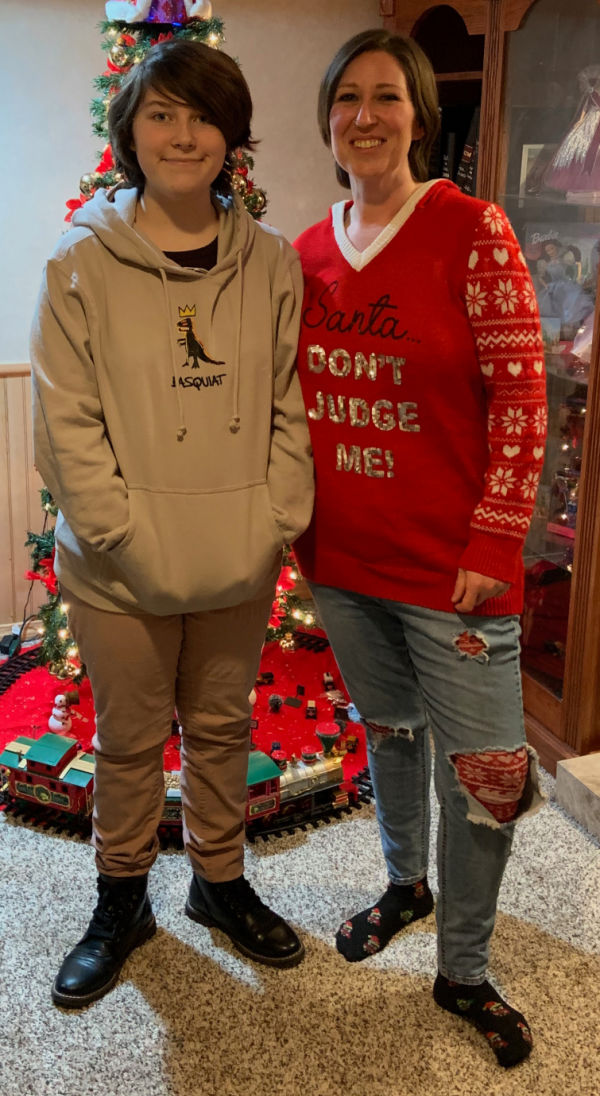 Mother and child in front of the Christmas tree.