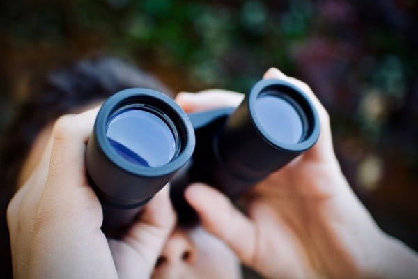 Woman looking through binoculars.