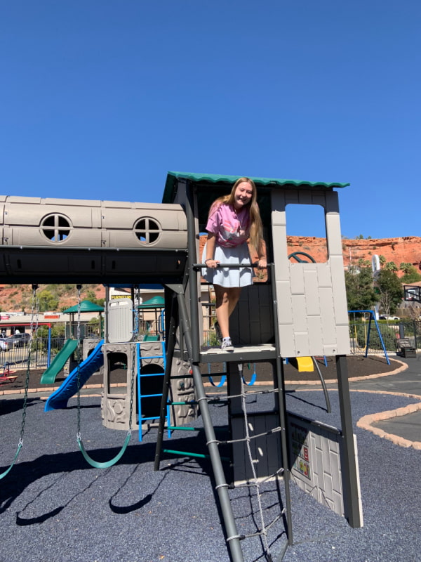 A teenage girl on a playground.
