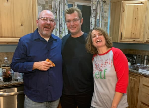 Two men and a lady at a Christmas party.