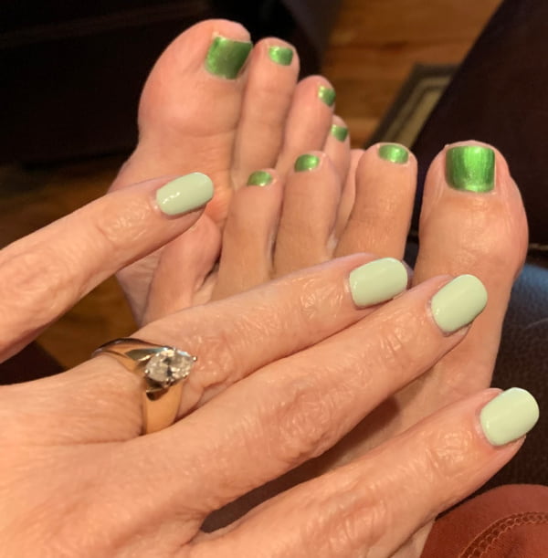 Fingernails and toenails painted green.