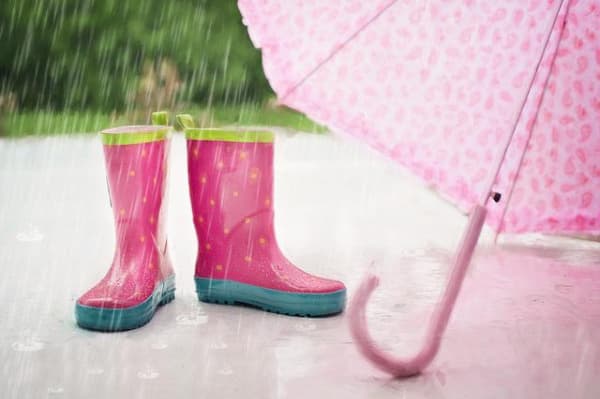 Pink rain boots and an umbrella.