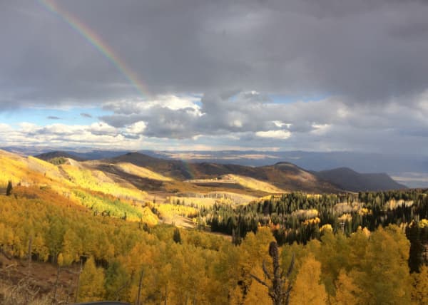 Rainbow over a canyon in fall.