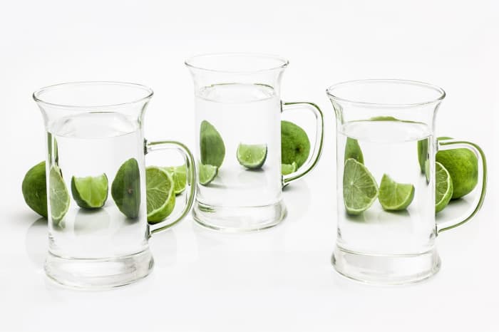 Three glasses of water and limes.