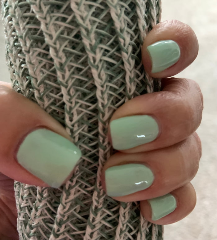 Mint green fingernails.