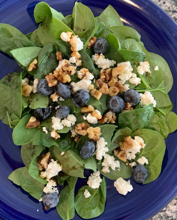 Spinach blueberry salad with feta cheese and walnuts.