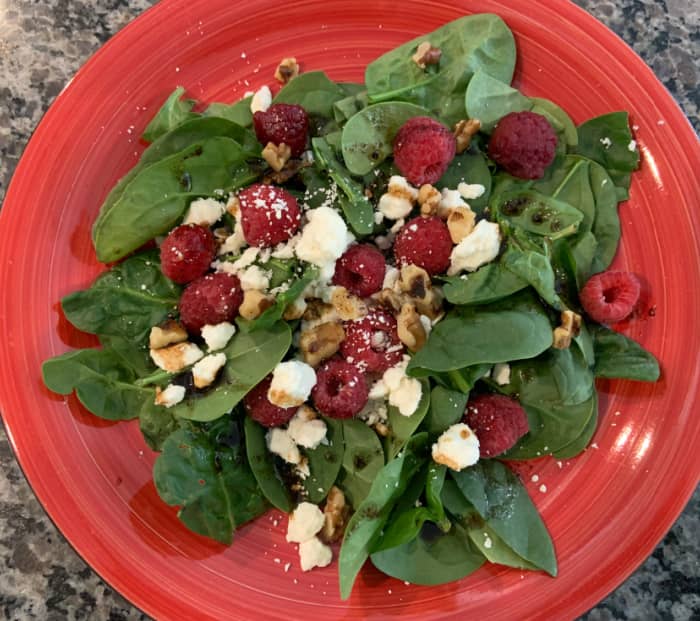 Spinach raspberry salad with feta cheese and walnuts.