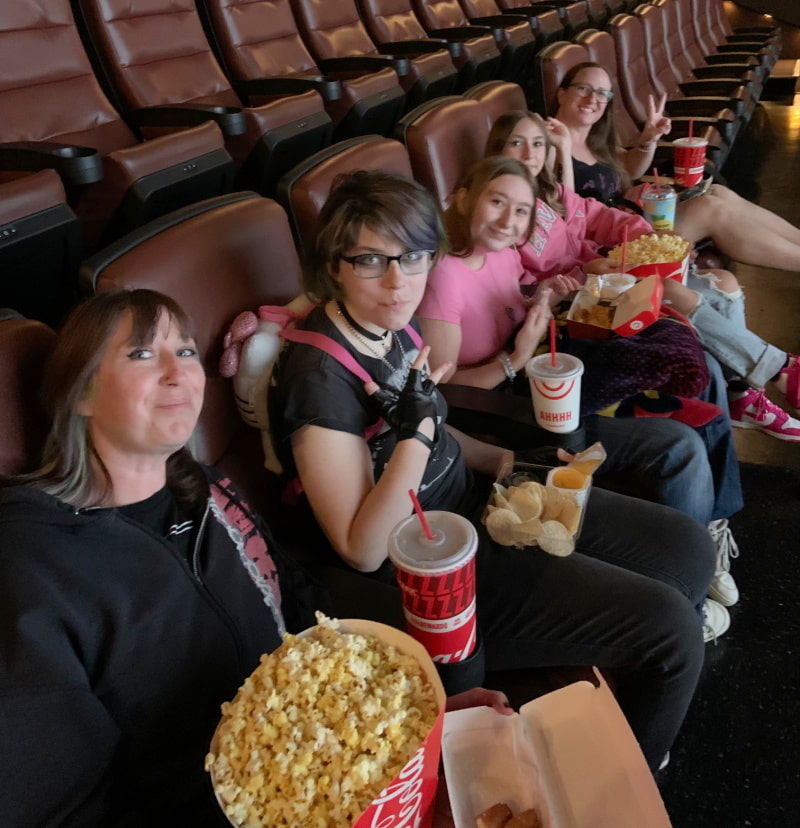 Five young women in a movie theater.