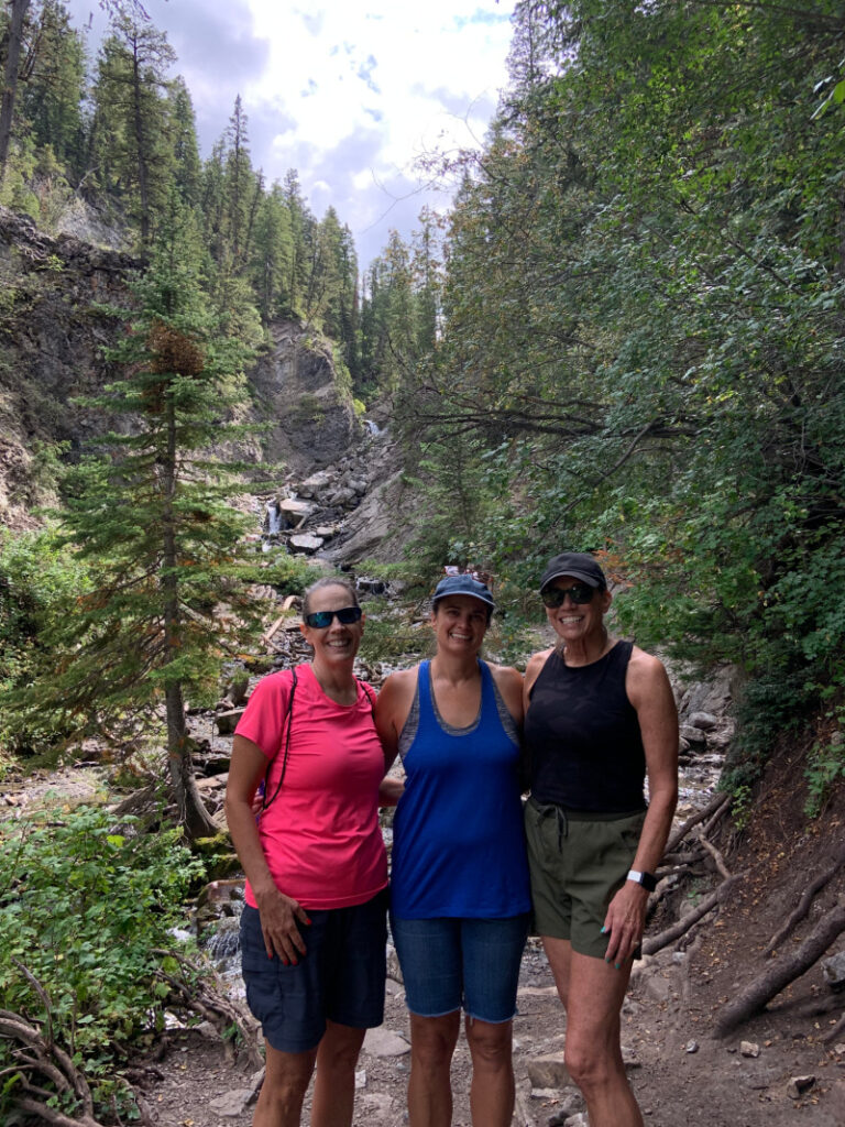 Three sisters in front of Donut Falls.