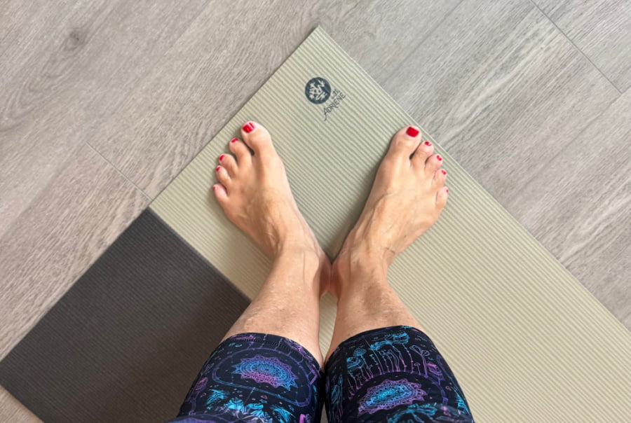 Woman's feet on a yoga mat.
