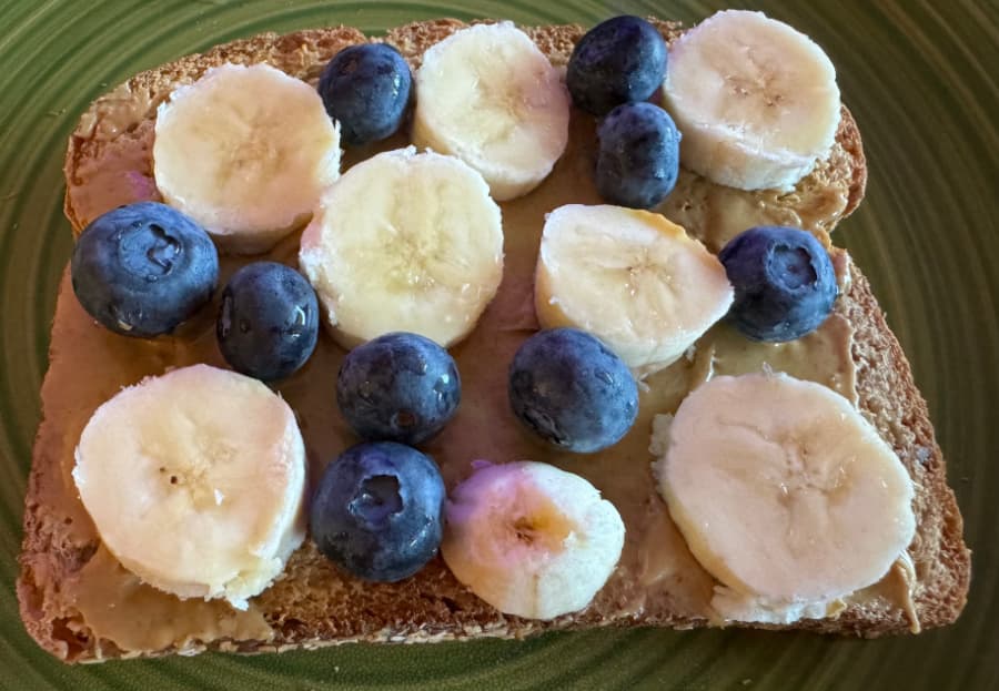 Peanut butter toast with bananas and blueberries.