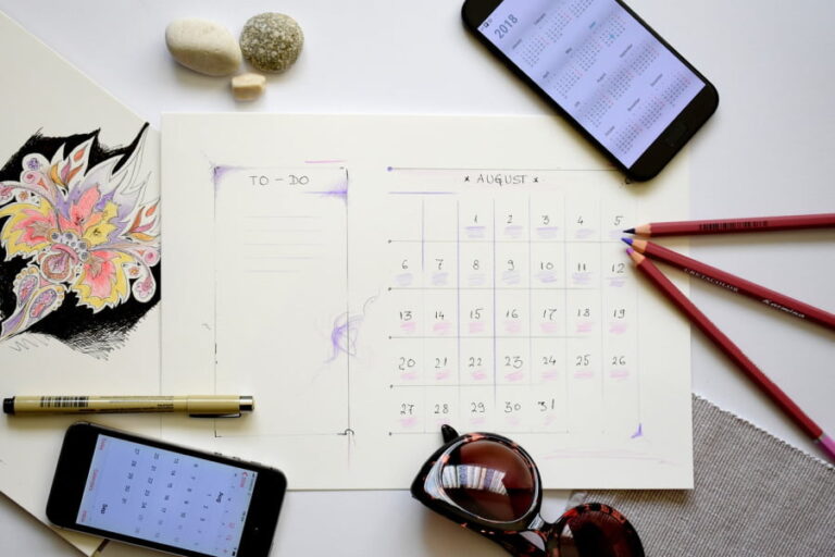 Calendar, sunglasses, art, and pencils.