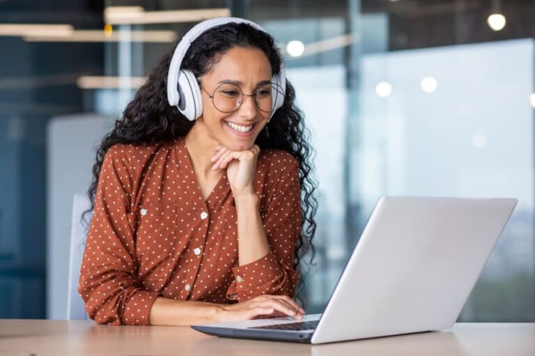 Woman with headphones and a laptop.