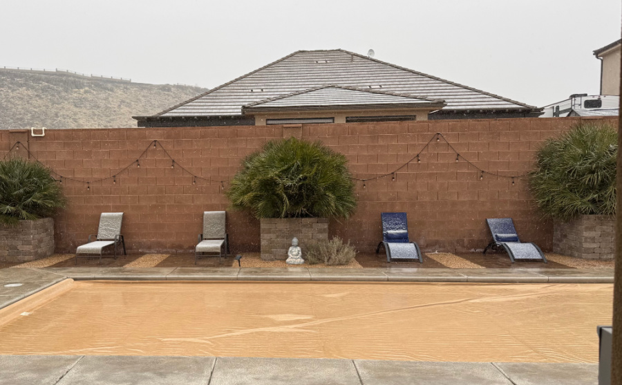 Pool chairs with a light dusting of snow.