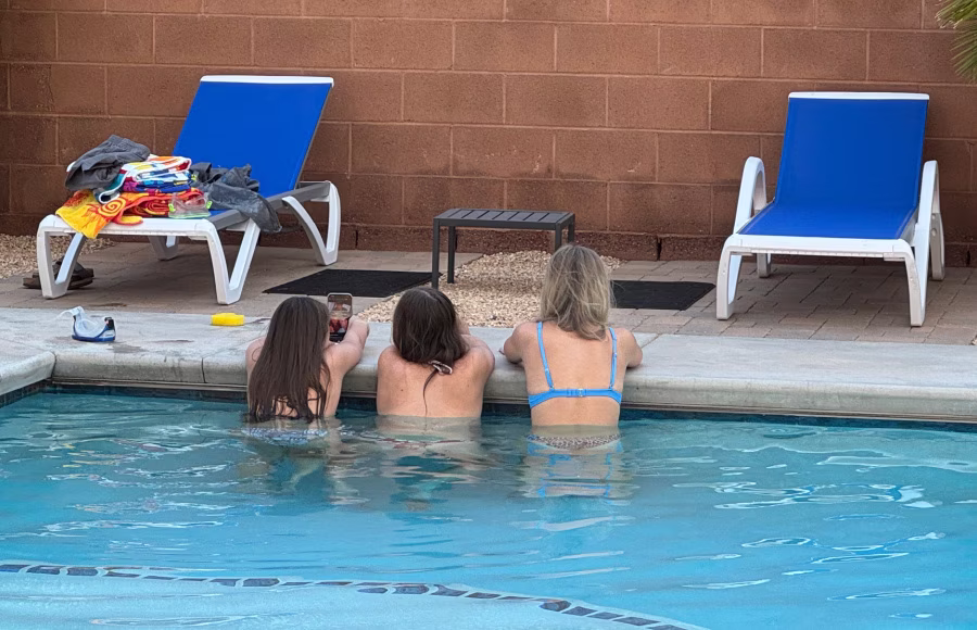 Three teenage girls in the swimming pool.