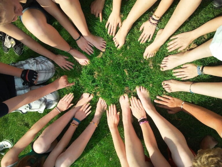 Hand and feet in a circle on the grass.