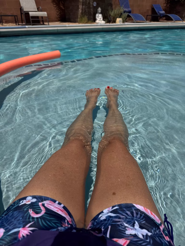 Woman's legs in a swimming pool.