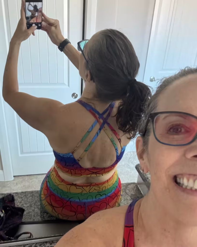 Woman wearing CVG True Colors shorts and bra set.