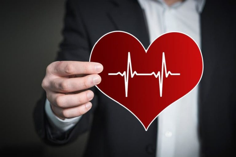 Man holding a red heart shape.