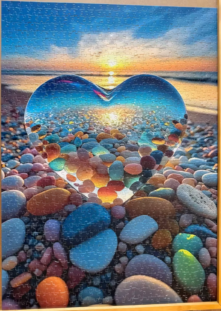 A jigsaw puzzle of colored rocks on the beach.