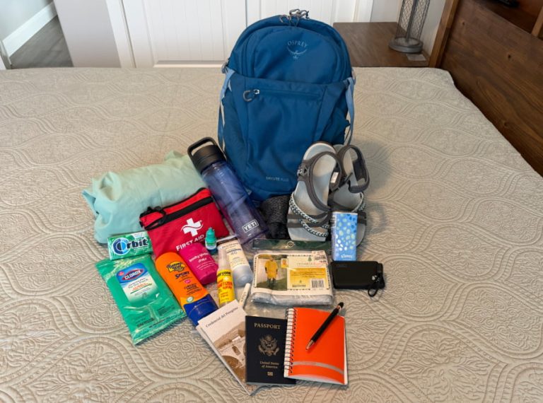 A backpack and items to put into it for a long hike.
