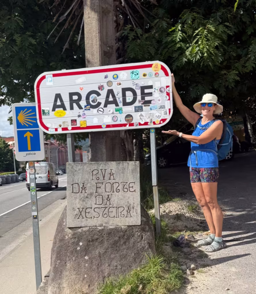Woman standing by a sign that says Arcade.