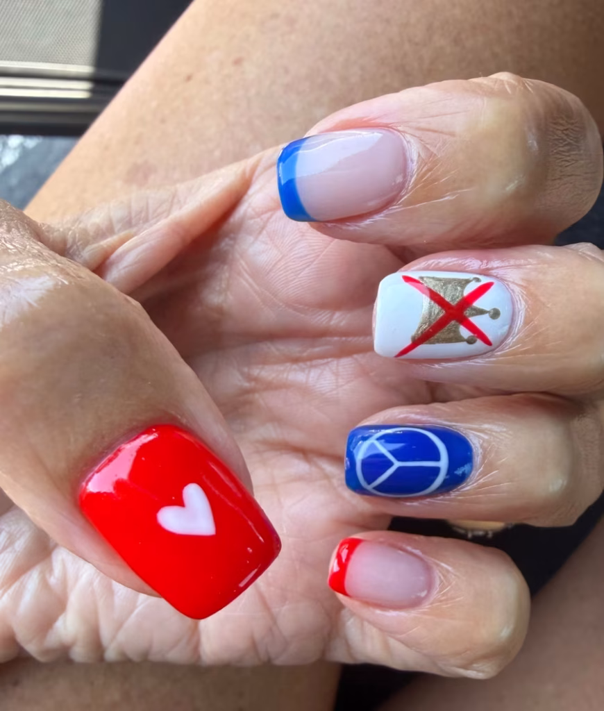 Red, white, and blue nail art, including a peace symbol, heart, and no kings symbol.