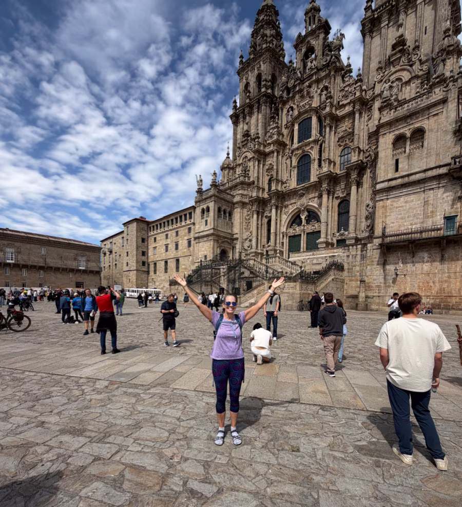 Woman celebrating in front of the Cathedral in Santiago de Compostela.