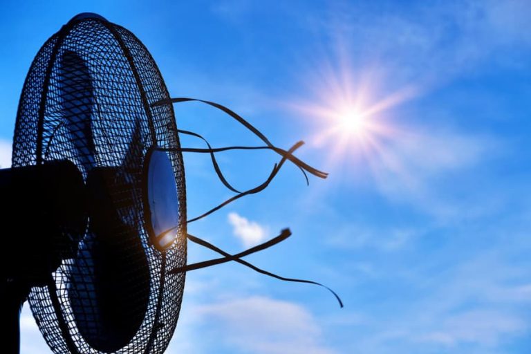 An electric fan under blue skies and sunshine.