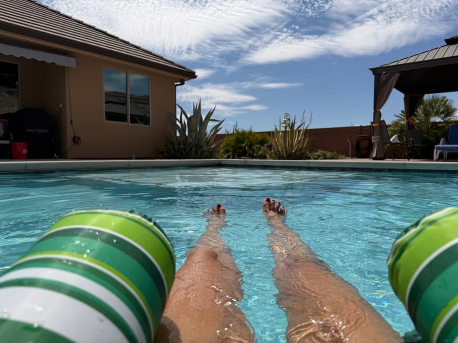 A woman floating in a swimming pool.