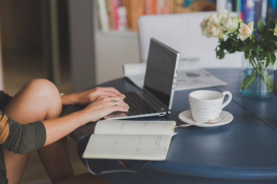 Woman typing on a laptop.