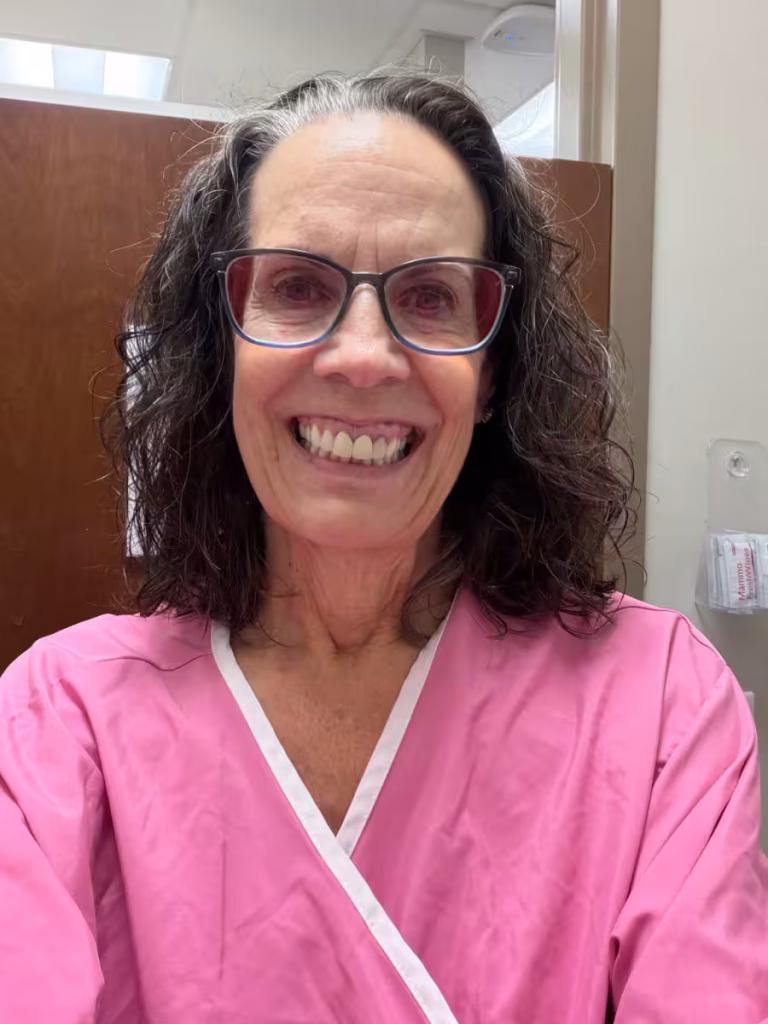 Woman in a pink hospital gown.